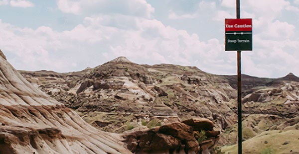 Mountain road with caution sign