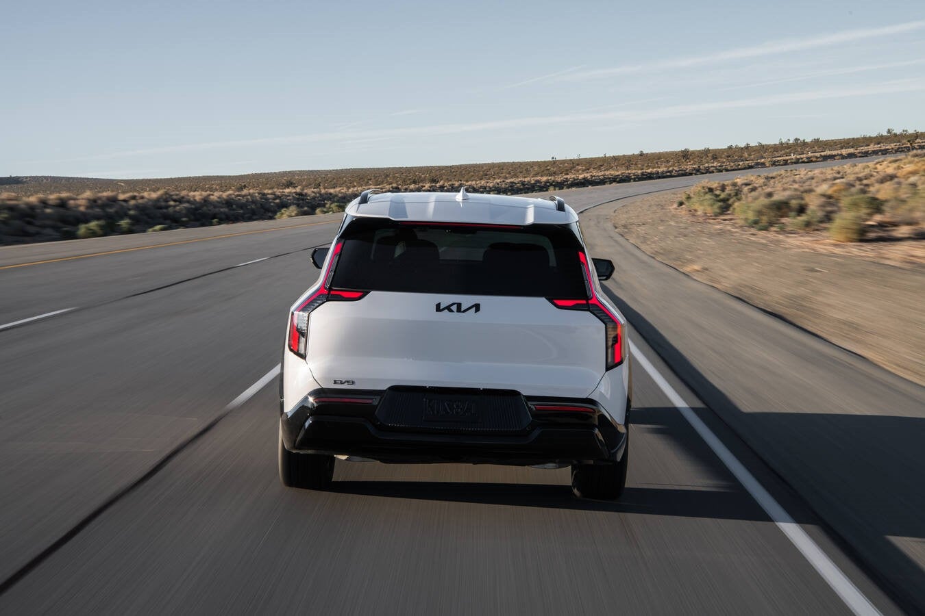Close-up of a Kia dashboard showing the widescreen digital display with navigation, climate, and Electric Vehicle information.