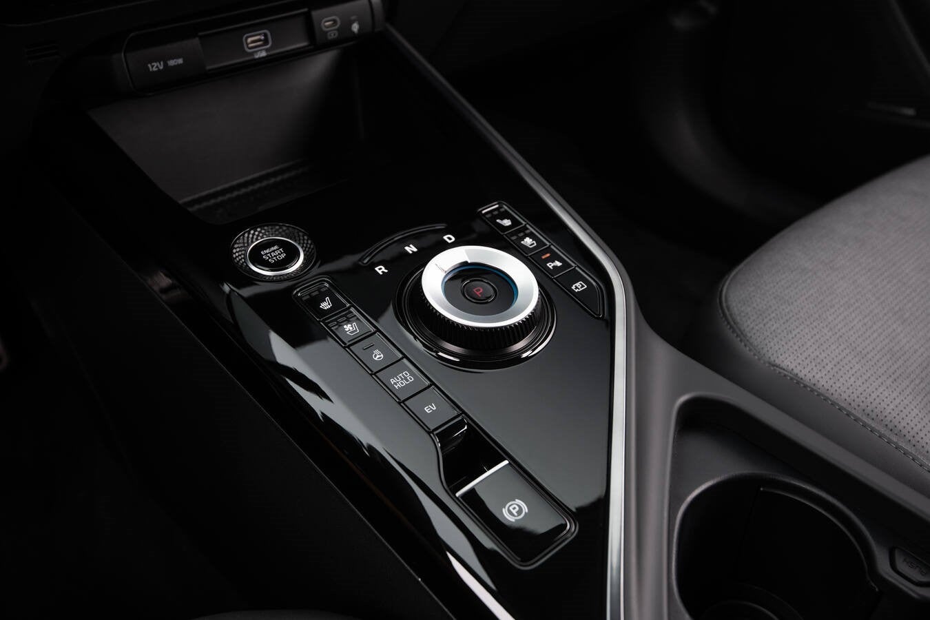 The black center console of the new Kia Niro is seen up close from the perspective of the driver of the Kia crossover SUV.