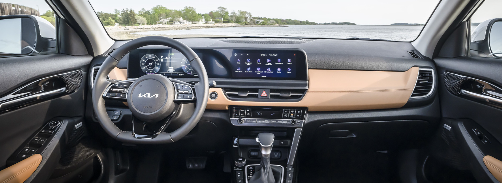 Kia Seltos interior with a digital dashboard and light-colored accents.